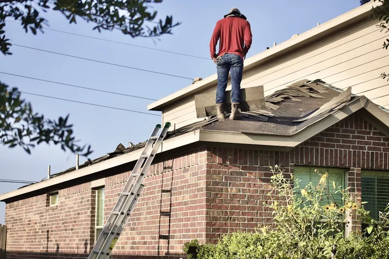 Professional roofer working on a residential roof in Fontana Gateway